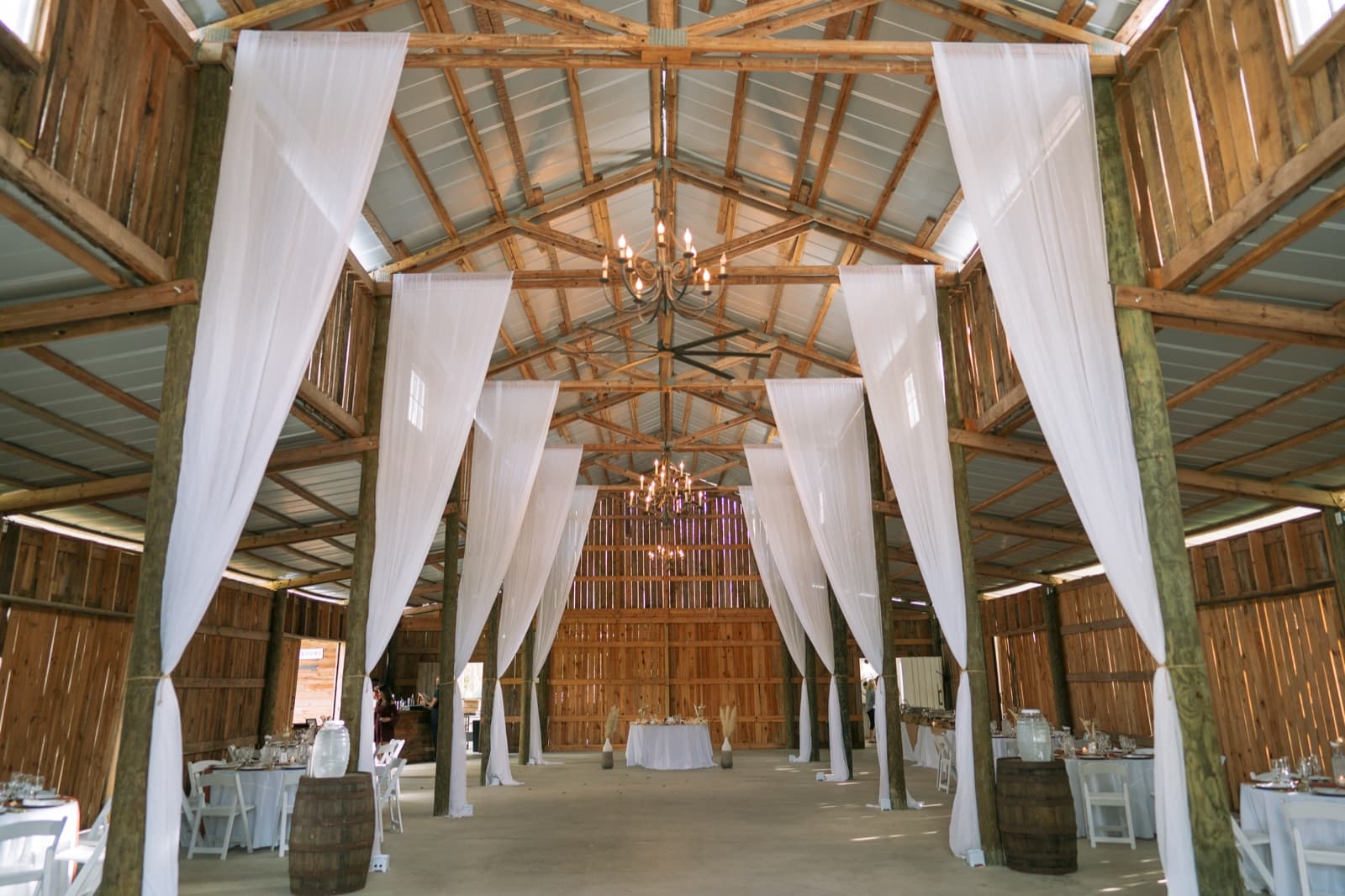 The barn interior, draped and set for the evening — Misty Morning Barn wedding venue, Fort Myers, Florida
