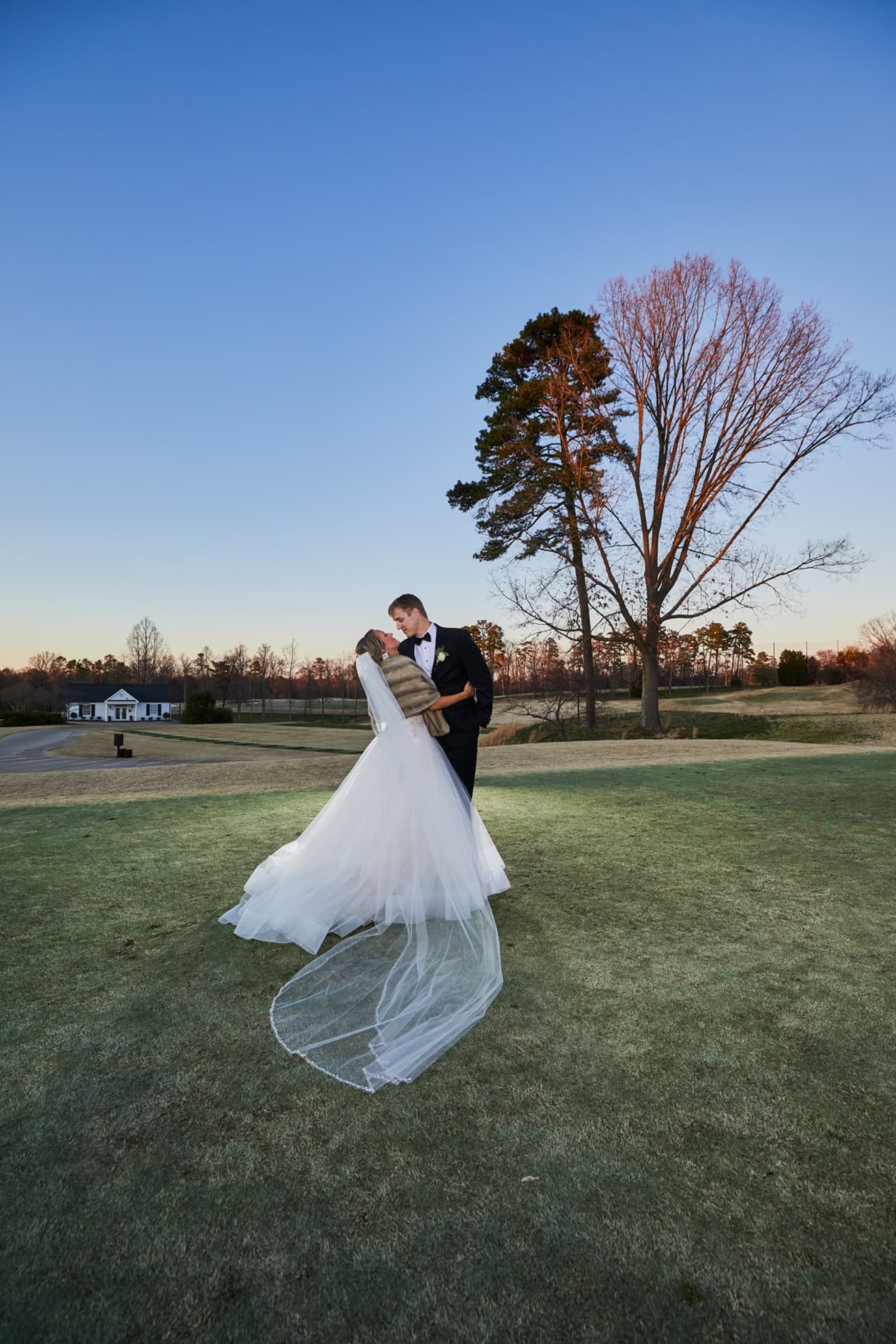 Winter blue-hour portrait on the fairway, veil spread across frosted grass — Forsyth Country Club