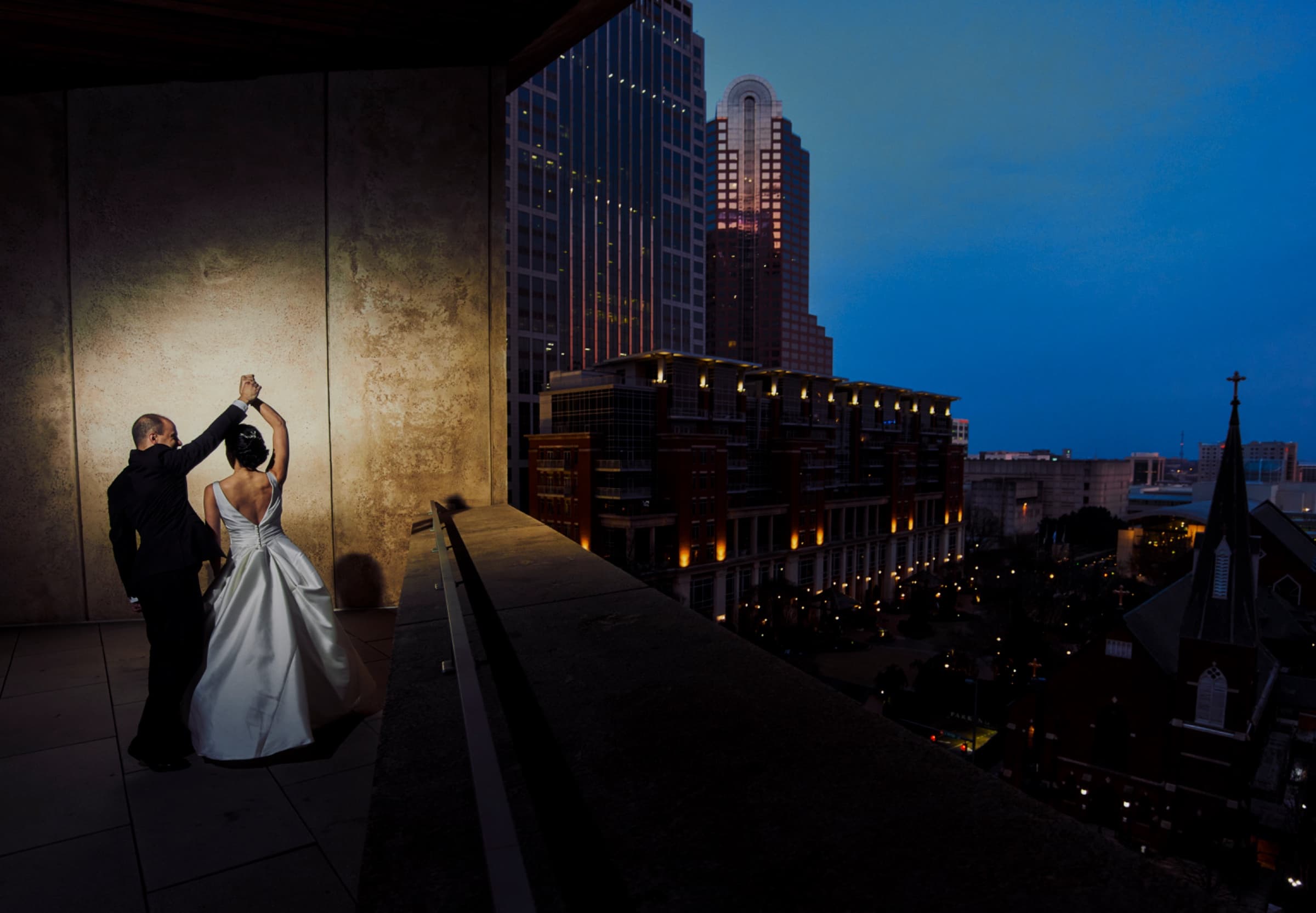 First dance on the rooftop terrace above the uptown streets at dusk — The Mint Museum