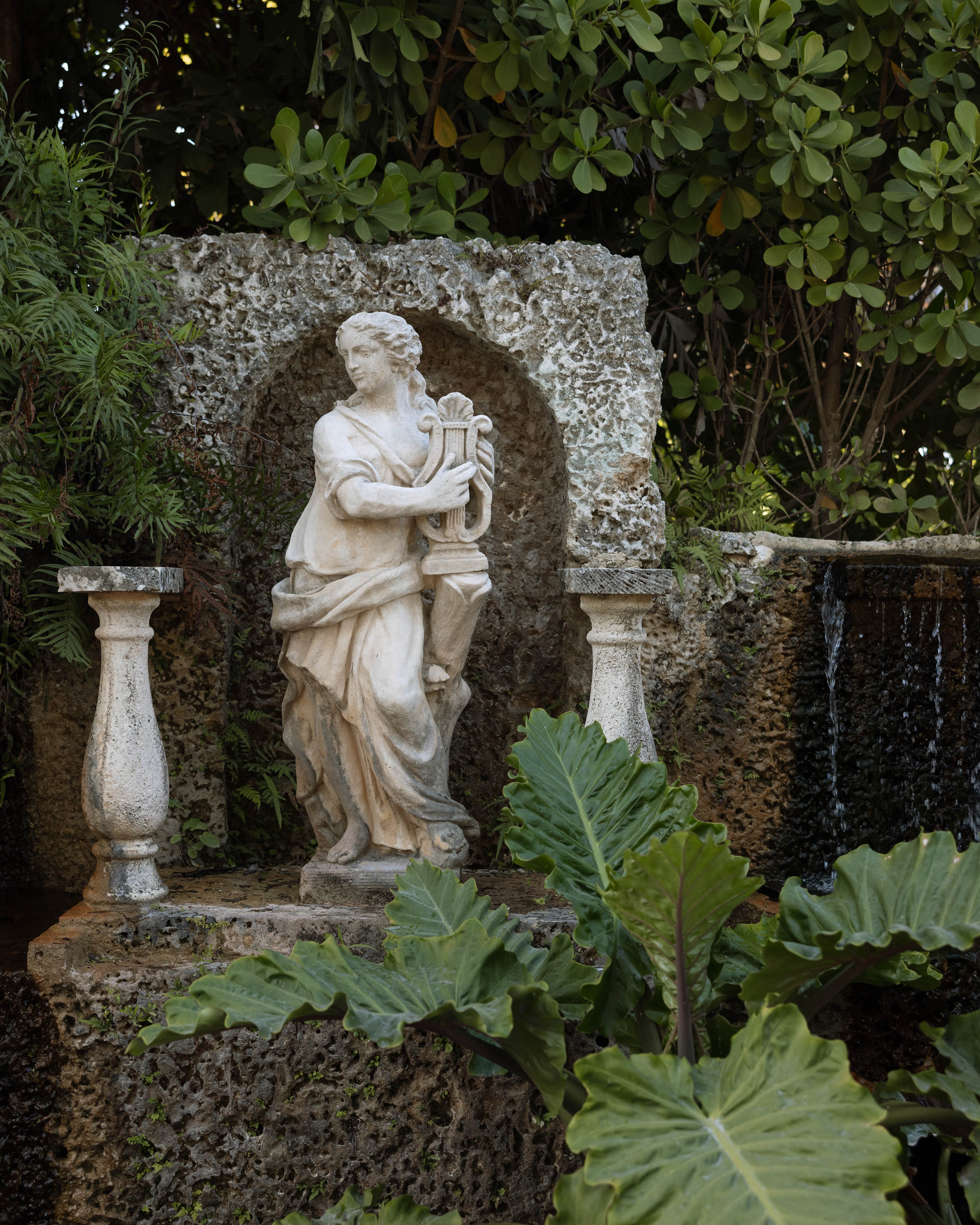 Classical statue in the garden grotto — Villa Toscana Miami wedding venue, Homestead, Florida