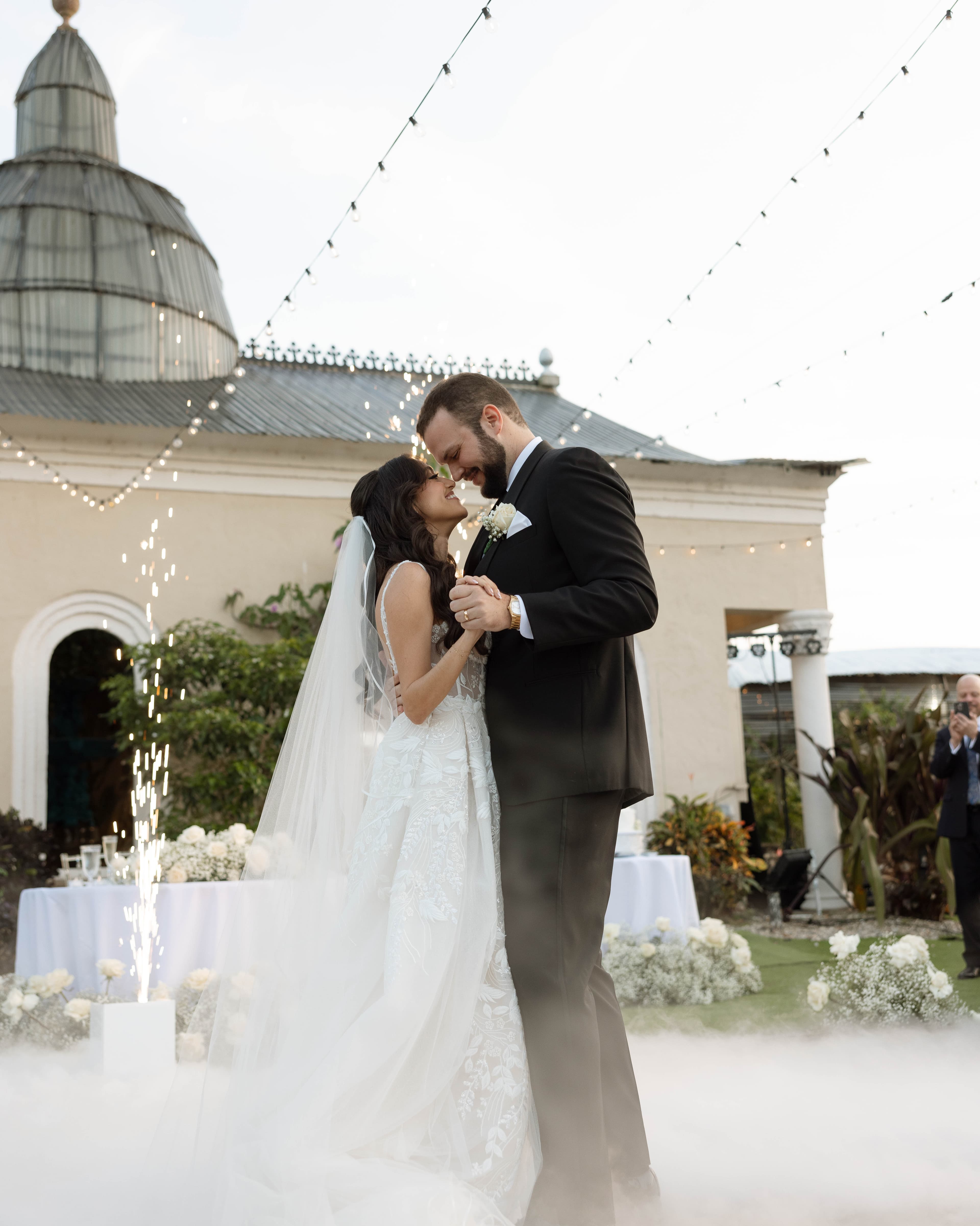 First dance beneath the cupola with fog and sparklers — Villa Toscana Miami wedding venue, Homestead, Florida