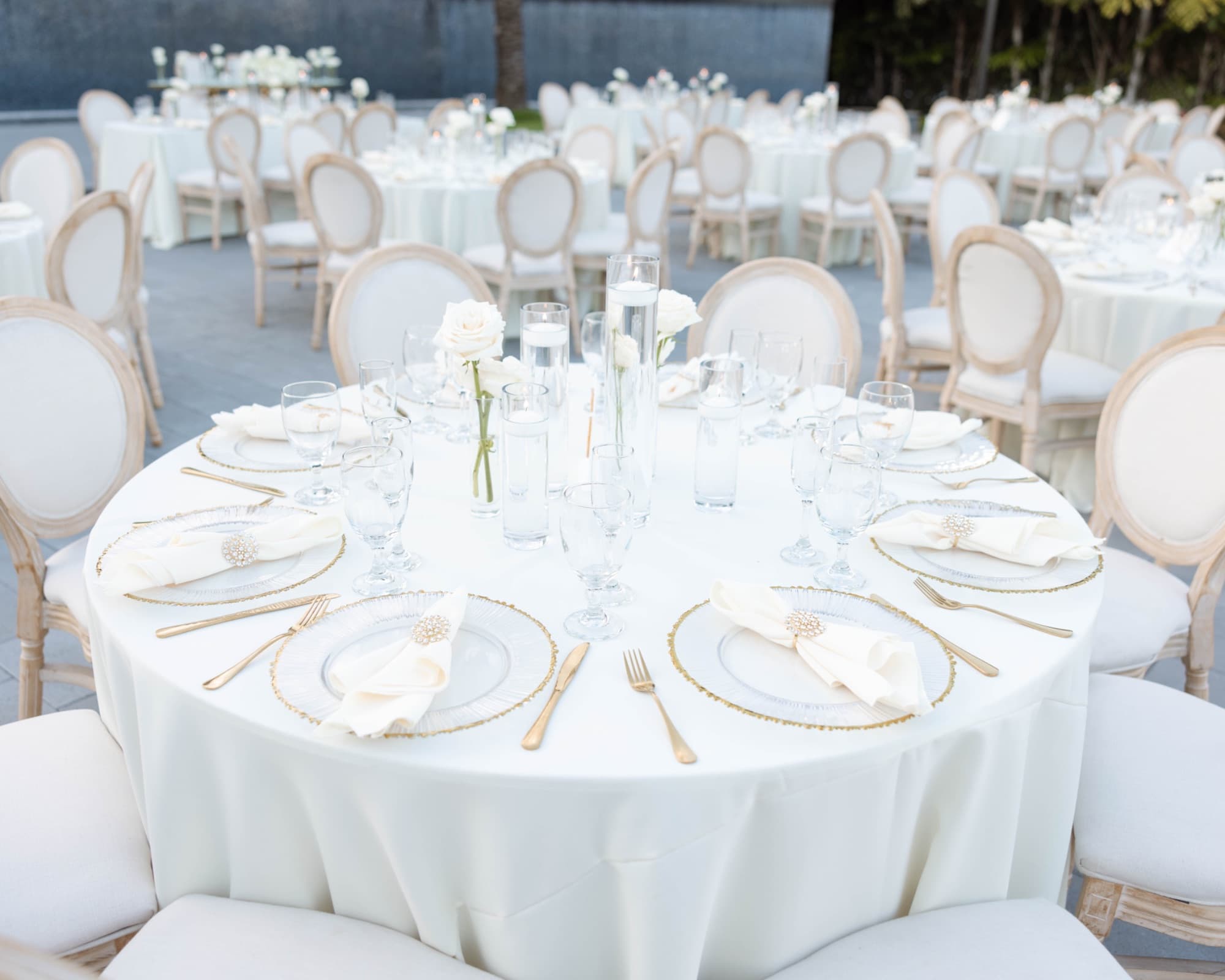 Round tables set in white and gold at The Glass Venue — The Glass Venue wedding venue, Miami, Florida