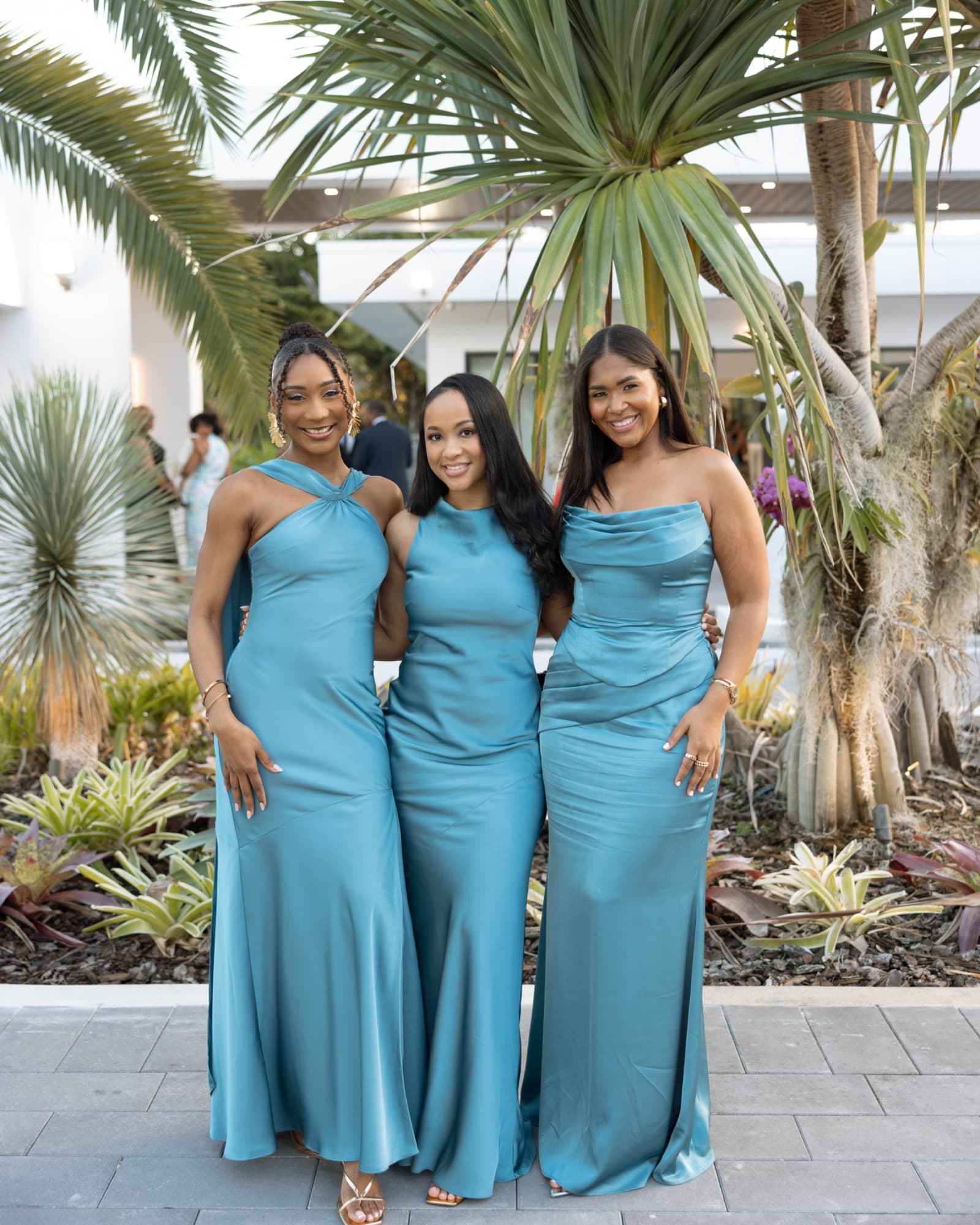 The bridesmaids in teal among the palms at The Glass Venue — The Glass Venue wedding venue, Miami, Florida